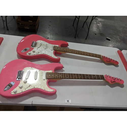 95 - Two Encore pink electric guitars