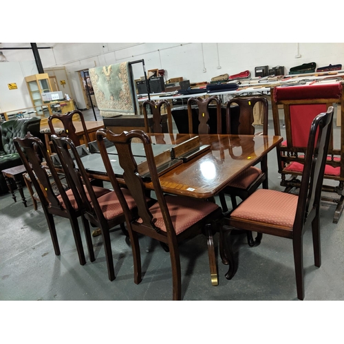 218 - A mahogany, twin pedestal, extending dining table and eight chairs