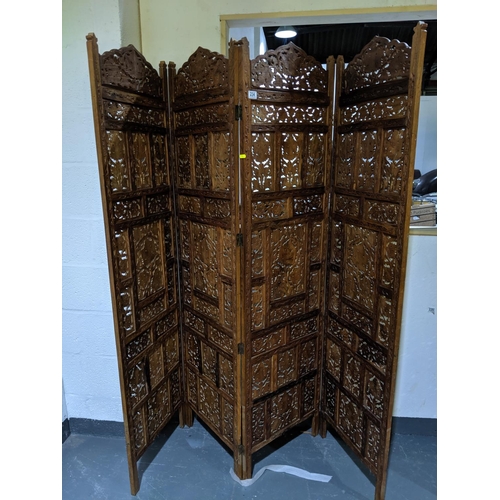 234 - A carved,wooden four fold screen