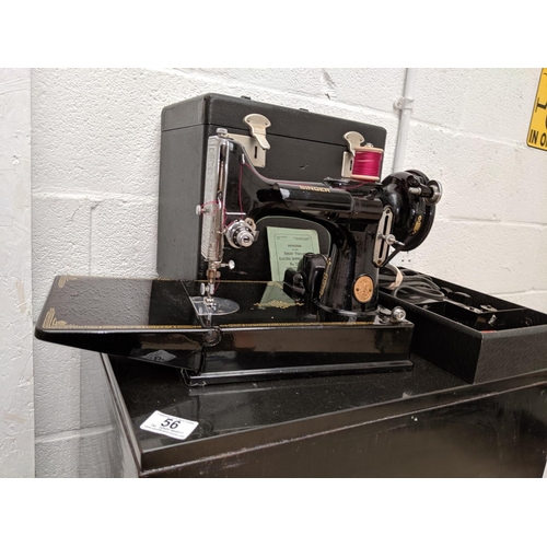 56 - A Singer 221K sewing machine with case, pedal, spools, needles etc- in immaculate condition