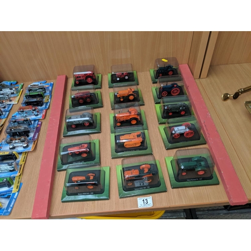 13 - A collection of model tractors in blister packs