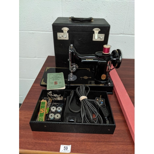59 - A Singer 221K sewing machine with case, pedal, spools, needles etc- in immaculate condition