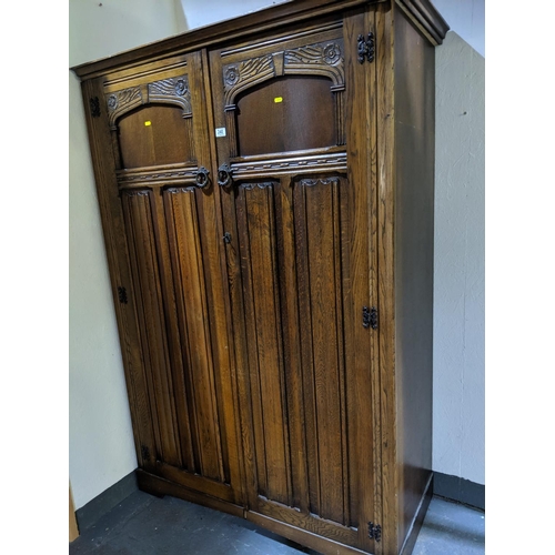 240 - An oak double door , linen fold wardrobe