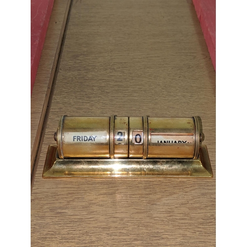 111 - Early 20th century brass perpetual rolling desk calendar of cylindrical form on moulded rectangular ... 