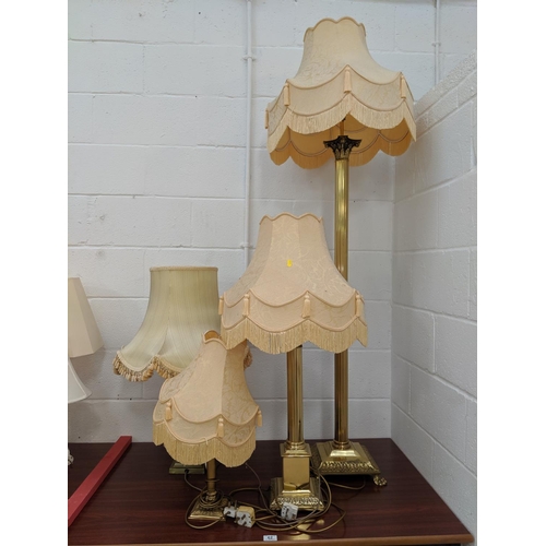 62 - Three large brass table lamps and one brass standard lamp