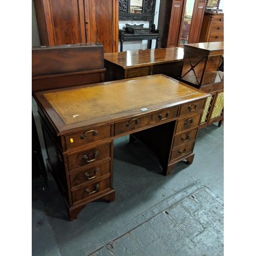 212 - A twin pedestal desk with a leather top insert