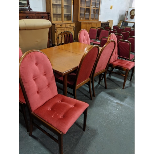 215 - A teak extending dining table and six chairs