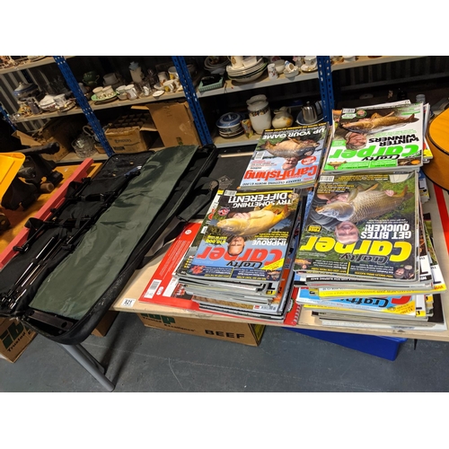 821 - A collection of carp fishing magazines and a rod rest