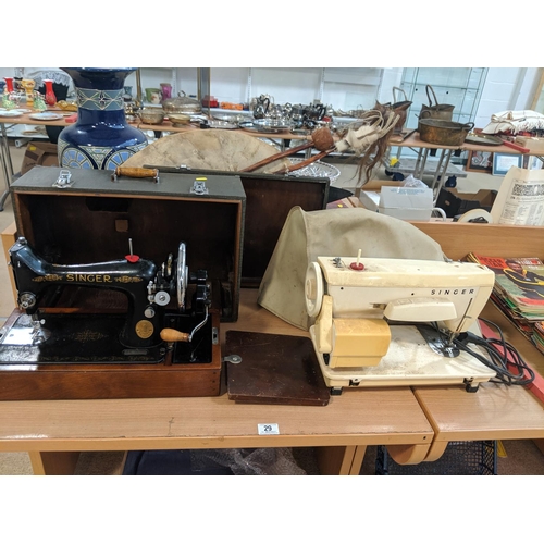 29 - A Signer hand crank sewing machine in case and a Singer electric sewing machine