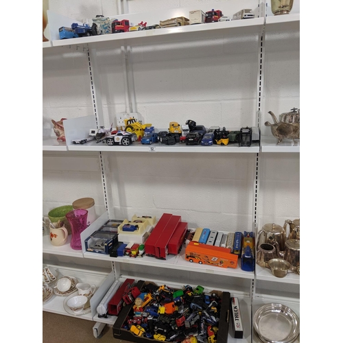 52 - Four shelves of vehicles including six Die Cast boxed Lledo etc.