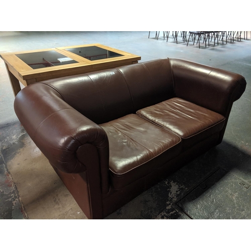 534 - A brown leather two seater sofa