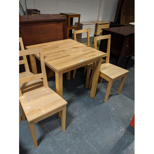 544 - A pine dining table and four chairs