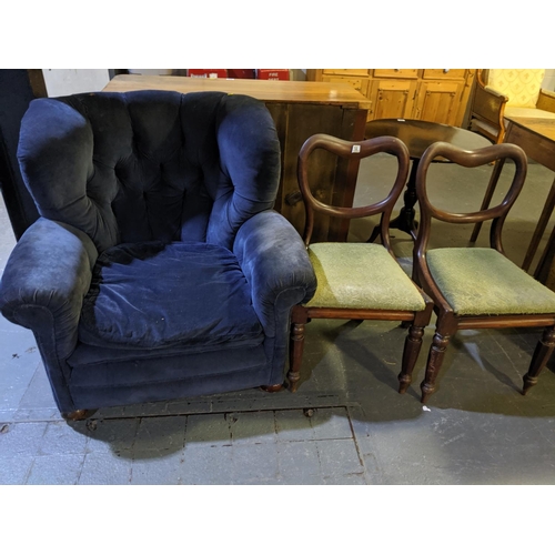 210 - An early upholstered armchair and two balloon back dining chairs