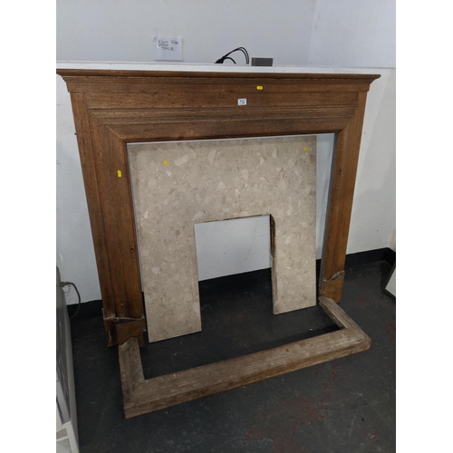 712 - An oak fire surround and marble fire insert