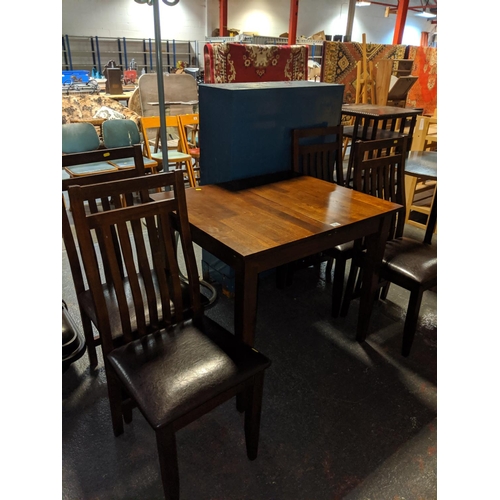 731 - A draw leaf dining table and four chairs with leatherette seats