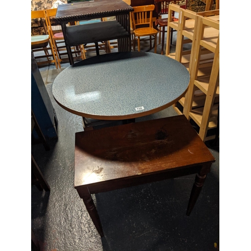 732 - A cast iron base table and a piano stool