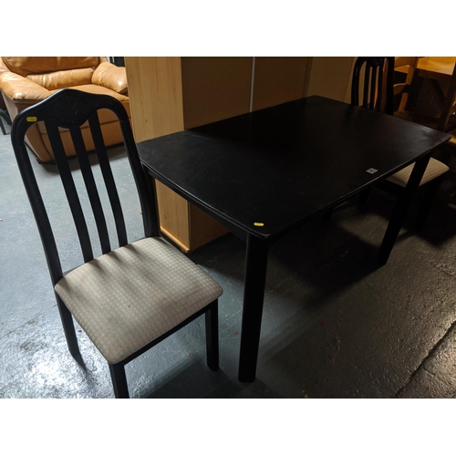 545 - A black painted table and two chairs