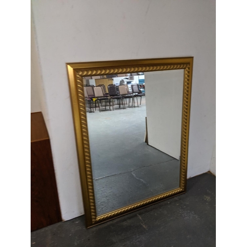 851 - A large gold framed mirror