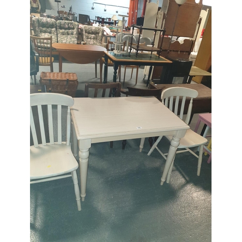 532 - A dining table and two chairs