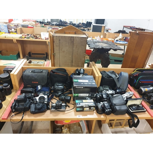 25 - A collection of cameras including Canon and Fujifilm