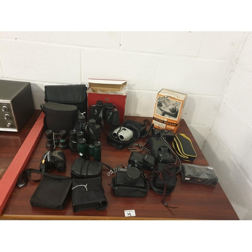 4 - A collection of cameras and binoculars