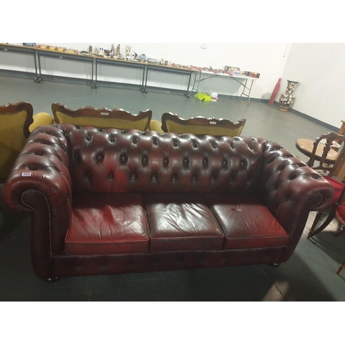 222 - A three seater red leather Chesterfield sofa