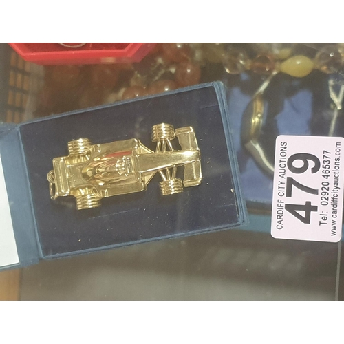 479 - A 9k gold formula one racing car pendant with a massive 46 gram weight - hallmarked