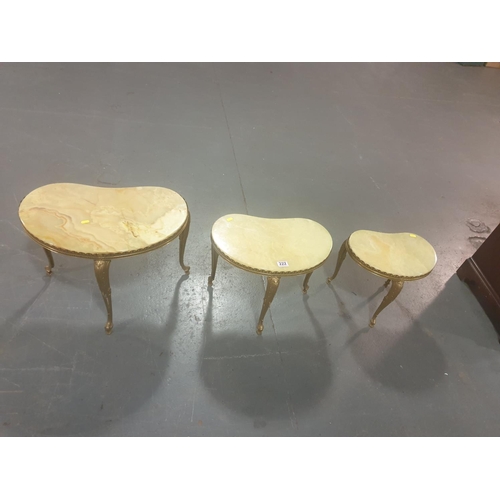 222 - A nest of three brass and marble tables