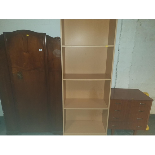 764 - A chest of drawers, wardrobe and a bookcase