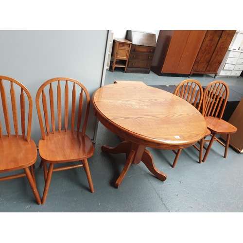 346 - An oak circular dining tabe and four chairs
