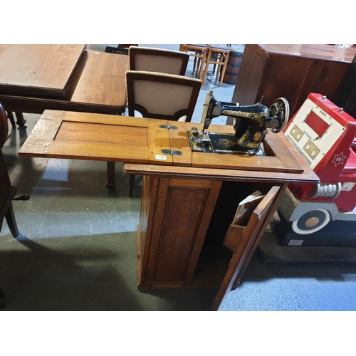 110 - A Singer sewing machine and treadle