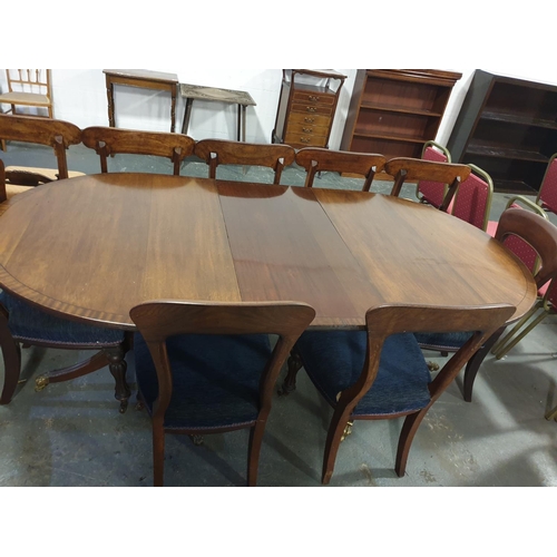 114 - A twin pedestal mahogany Regency style dining table with four genuine Regency chairs