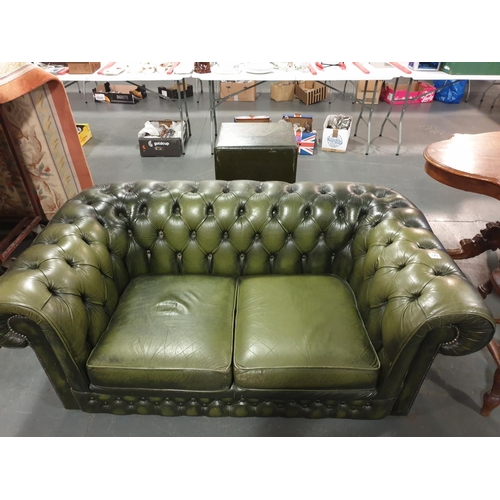 120 - A green leather Chesterfield button backed two seater sofa