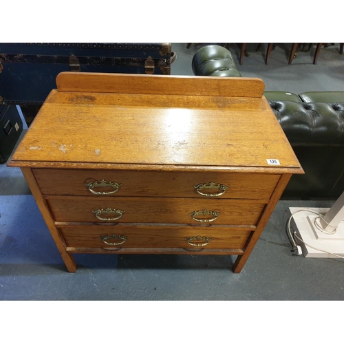 125 - An oak three drawer chest of drawers