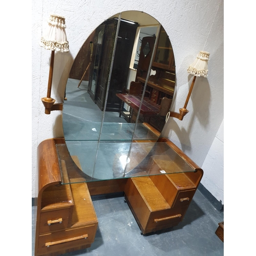 128 - An oak Art Deco dressing chest with an oval mirror and lamps