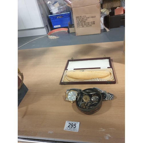 295 - Two watches (one watch marked Rolex) and a tin of military buttons