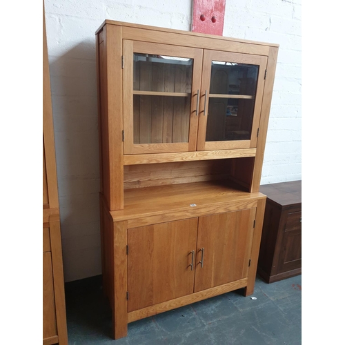 508 - A solid oak sideboard with glazed shelving above