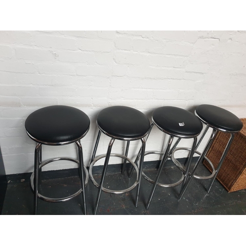 519 - A set of four chrome and black upholstered bar stools