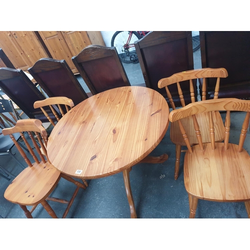 538 - A circular pine dining table and four chairs