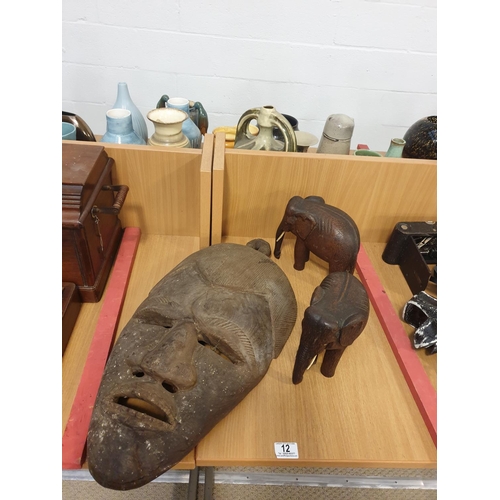12 - An African mask and other African carvings