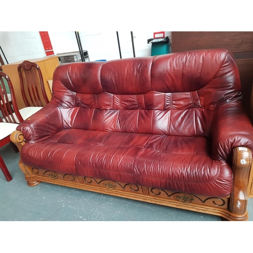 339 - A wooden framed red leather 3 seater sofa
