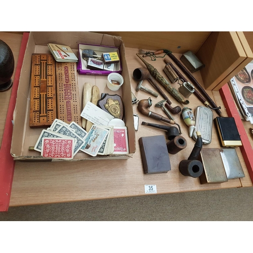 35 - A collection of pipes, including an oriental brass Opium pipe, cigarette boxes and other vintage ite... 