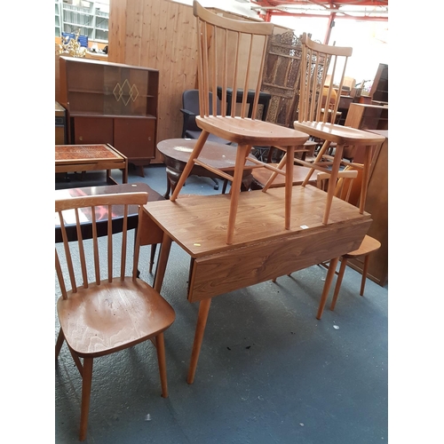 535 - A drop leaf dining table and four chairs.