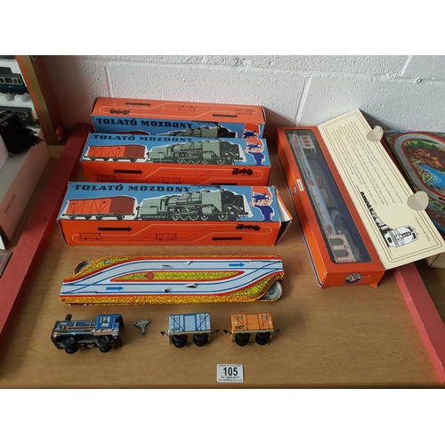 105 - Three boxed Hungarian (Tolato Mozdony) tin train sets plus a Lionel trains 'Train Stop' tin set