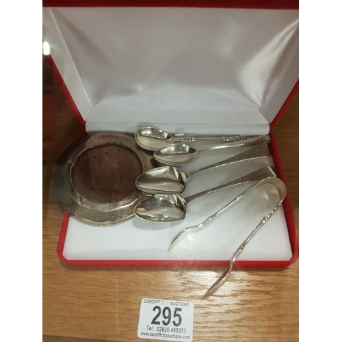 295 - Silver teaspoons, sugar tongs & picture frame - in excess of 78 grams