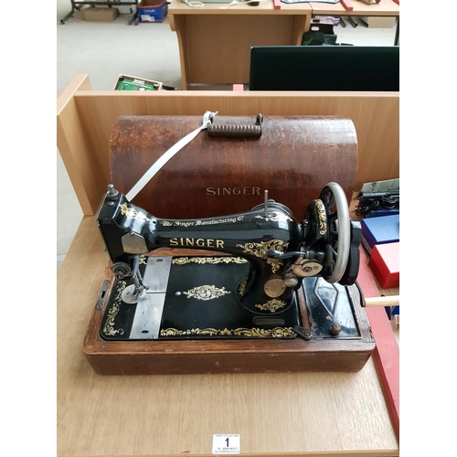 1 - A hand crank Singer sewing machine in wooden case with key