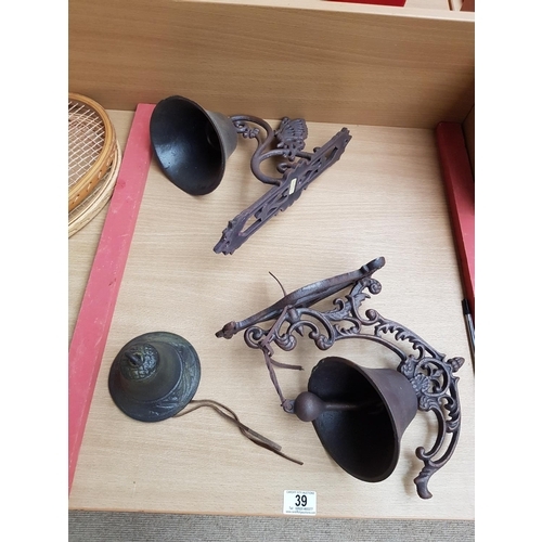 39 - Two cast iron wall hanging bells etc