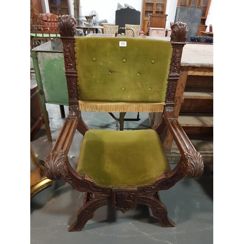 256 - A Victorian heavily carved X framed Oak chair