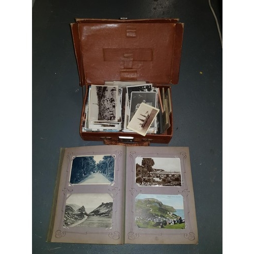 300 - An early postcard album with cards and a leather case with a large quantity of postcards