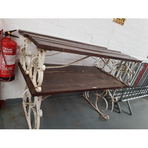 506 - An iron based wooden topped table with 2 matching benches